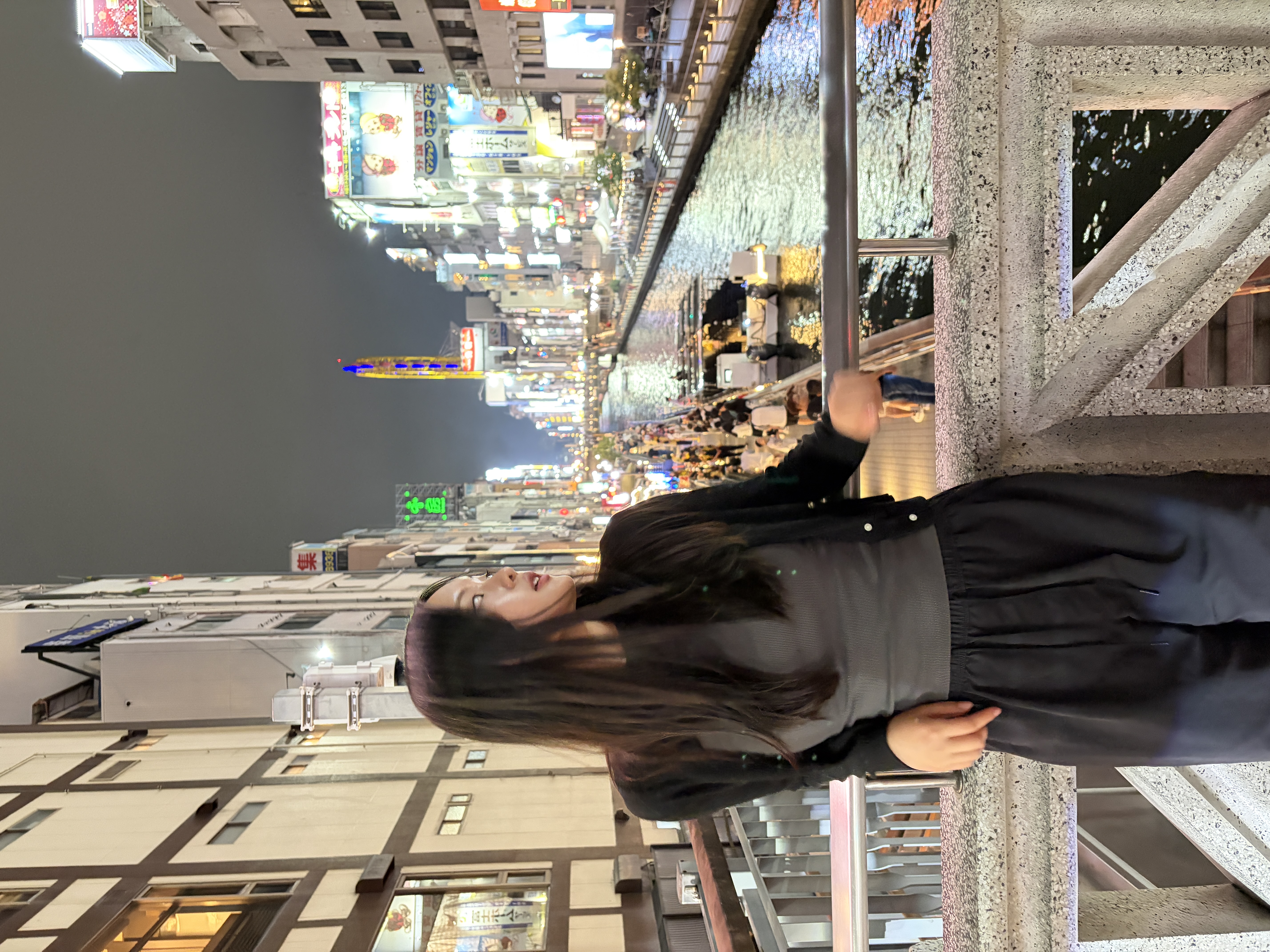 Brenda standing by a city canal at night