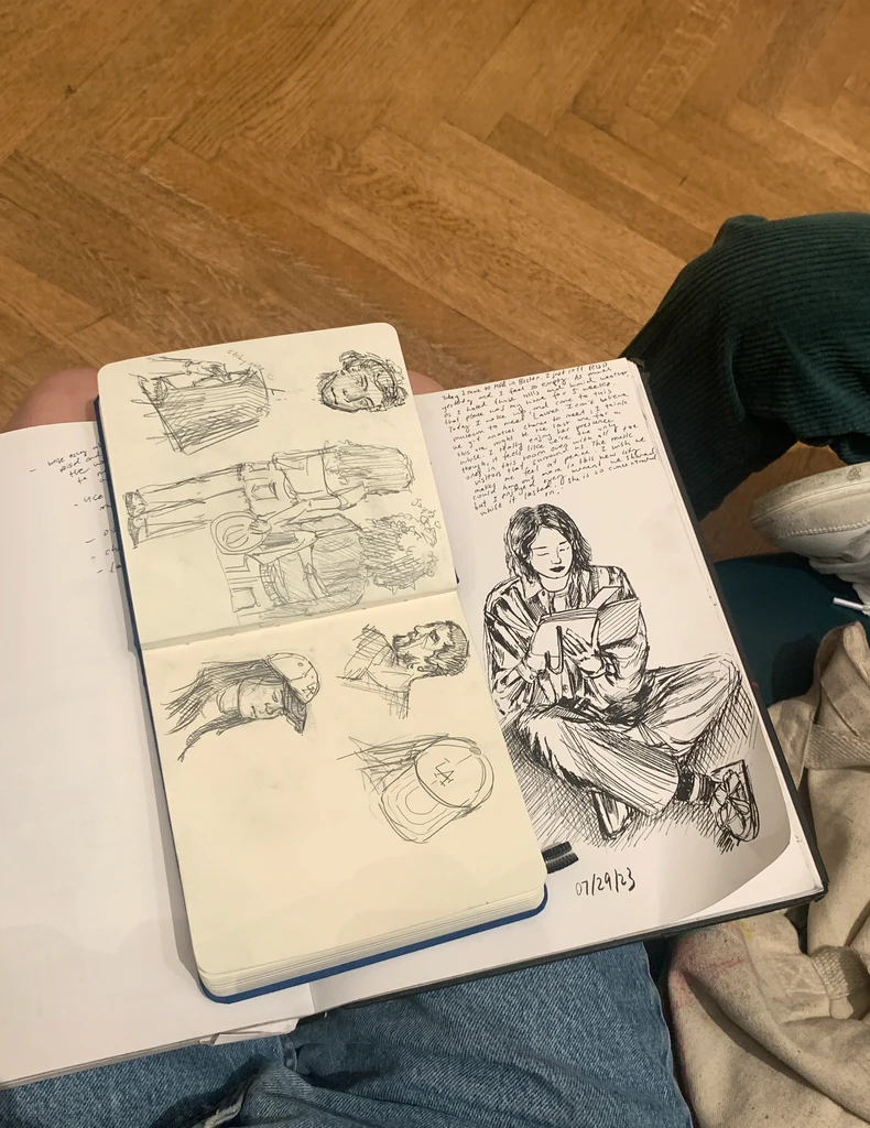 Open sketchbooks with ink drawings and handwritten notes